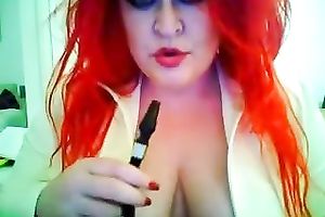 This red-haired seductress with large boobs looks so hawt whilst smokin'