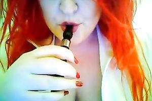 This red-haired seductress with large boobs looks so hawt whilst smokin'