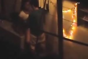Naughty pair in the next building having sex on the balcony