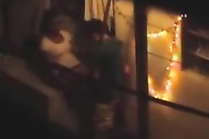 Naughty pair in the next building having sex on the balcony