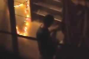 Naughty pair in the next building having sex on the balcony