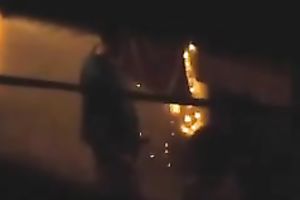 Naughty pair in the next building having sex on the balcony