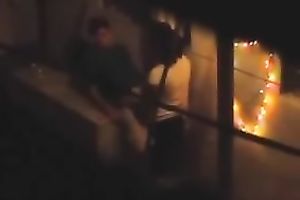 Naughty pair in the next building having sex on the balcony