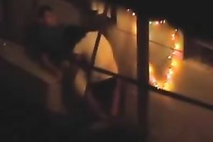 Naughty pair in the next building having sex on the balcony
