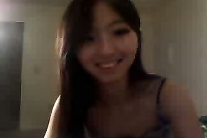 Cute Asian dark brown legal age teenager stripteasing on livecam and playing