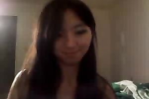 Cute Asian dark brown legal age teenager stripteasing on livecam and playing