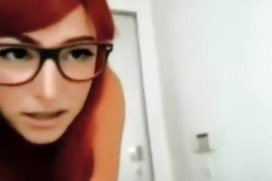 Mouth-watering redhead in glasses gives worthy footjob to her fuck buddy