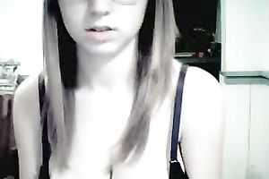 Amateur gal in glasses shows her attractive jugs for the webcam