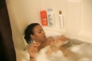 Black hottie smokes whilst taking a baths and sucks a penis