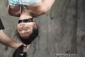 Suspended Asian honey receives face-fucked with a vibrator in BDSM movie
