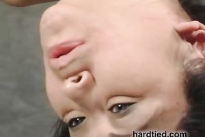 Suspended Asian honey receives face-fucked with a vibrator in BDSM movie