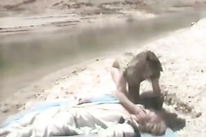 Blonde playgirl receives undressed and gives head on the beach