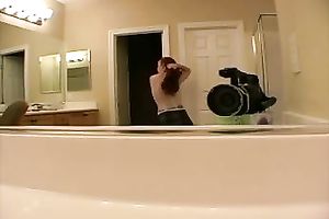 Playful redhead doxy exposes her almost bare body