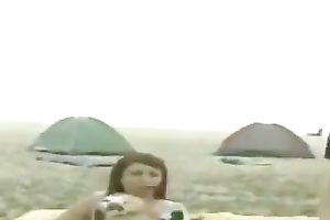 Playful non-professional lalin girl chicks on the beach jumping on a daybed