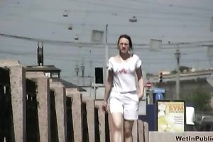 Amateur dark brown Russian playgirl in white shorts piddles in public