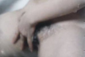 Shy looking hot chick passionately fingers her kitty whilst taking shower