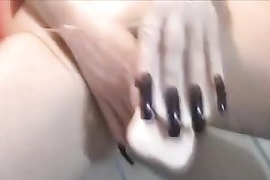 My long-nailed paramour satisfies herself with the assist of a sex-toy