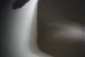 Curvaceous dark brown honey puts on her garments in locker room