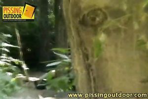 Two enjoyable blond beauties kiss in the forest and piddle