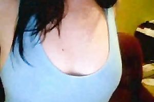 Amateur brunette hair hussy shows her breasts and pierced tongue