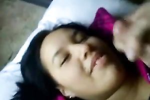 Brunette cutie lies in front of me during the time that I splatter her face with cum