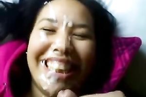 Brunette cutie lies in front of me during the time that I splatter her face with cum