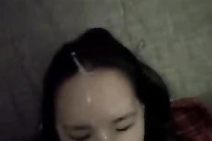 Brunette cutie lies in front of me during the time that I splatter her face with cum