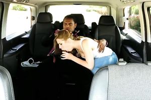 Blonde hussy gives head to a dark stud in a minivan