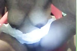 Black wench plays with her pantoons on camera in her room by squeezing them