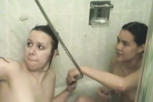 Asian honey and her bulky ally take a washroom jointly in lesbo vid
