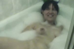 Pigtailed Asian gal smashes her vag with a dildo in the bath
