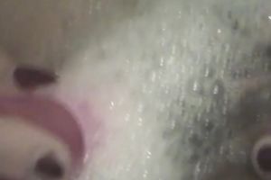 Pigtailed Asian gal smashes her vag with a dildo in the bath