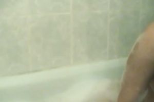 Pigtailed Asian gal smashes her vag with a dildo in the bath