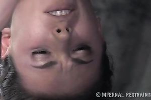 Dissolute dark brown babe bounded with leather and iron device for punishment