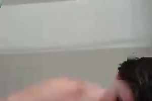 Lubricious bitch acquires into a bathtub and begins masturbating