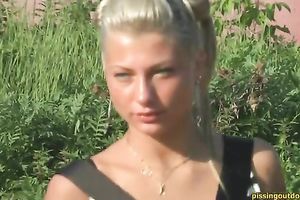 Lustful blond bitch pees behind the garage underneath the sun