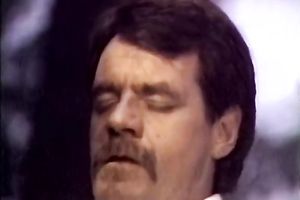 Curly brunette hair chick in red garments sucks penis like a domme