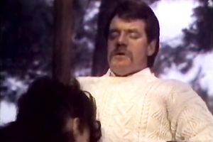 Curly brunette hair chick in red garments sucks penis like a domme