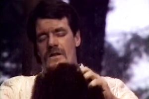 Curly brunette hair chick in red garments sucks penis like a domme