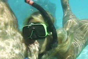 Blonde babe sucks a jock beneath water and receives drilled from behind