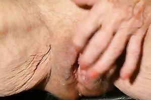 Old dissolute woman is finger banging her pretty pink muff