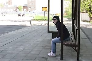 Brunette skank pees in her jeans at a busstop and enjoys herself