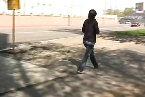 Brunette skank pees in her jeans at a busstop and enjoys herself