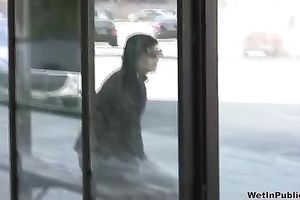 Brunette skank pees in her jeans at a busstop and enjoys herself