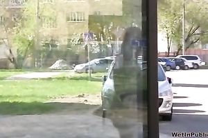 Brunette skank pees in her jeans at a busstop and enjoys herself
