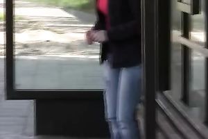 Brunette skank pees in her jeans at a busstop and enjoys herself