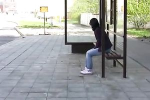 Brunette skank pees in her jeans at a busstop and enjoys herself