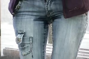 Brunette skank pees in her jeans at a busstop and enjoys herself