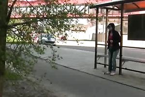 Brunette skank pees in her jeans at a busstop and enjoys herself