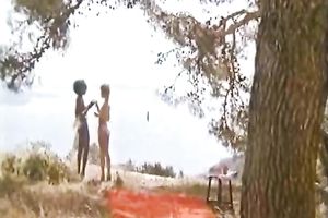 Ebony chick and slender European slutty wife having lesbo enjoyment outdoors